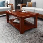 Business office coffee table with a sleek design, premium material, and lower shelf for storage, placed in a modern office setting.
