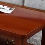 Business office coffee table with a sleek design, premium material, and lower shelf for storage, placed in a modern office setting.