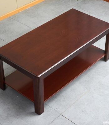 Business office coffee table with a sleek design, premium material, and lower shelf for storage, placed in a modern office setting.