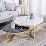 A pair of elegant marble tables with unique veining patterns, placed next to each other in a stylish living room setting.