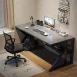Computer desk with built-in shelf, spacious work surface, and additional storage for office essentials.