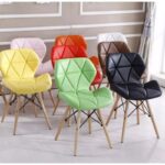Eames Padded Dining Chair with wooden legs in a modern dining room setting.