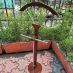 Executive Coat Hanger made from wood and metal with multiple hooks for organizing coats and outerwear.