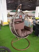 Hammock outdoor swing hanging in a garden, offering a comfortable and relaxing spot for lounging.