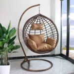 Hammock outdoor swing hanging in a garden, offering a comfortable and relaxing spot for lounging.