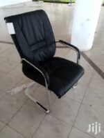 Comfortable and stylish executive visitor seat in a professional office setting.