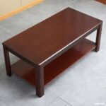 Modern solid wood coffee table with clean lines and natural wood finish, perfect for contemporary living spaces.