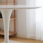 A modern round office dining table, designed for professional settings, offering a sleek and functional space for dining or meetings.