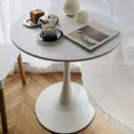 A modern round office dining table, designed for professional settings, offering a sleek and functional space for dining or meetings.